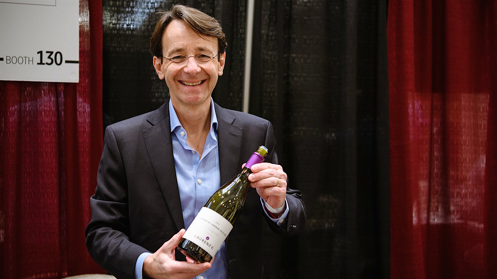 Dieter H&uuml;bler at the 2026 Wine Spectator Grand Tour in Denver, Colorado, holding a bottle of Laurenz V. Gr&uuml;ner Veltliner.