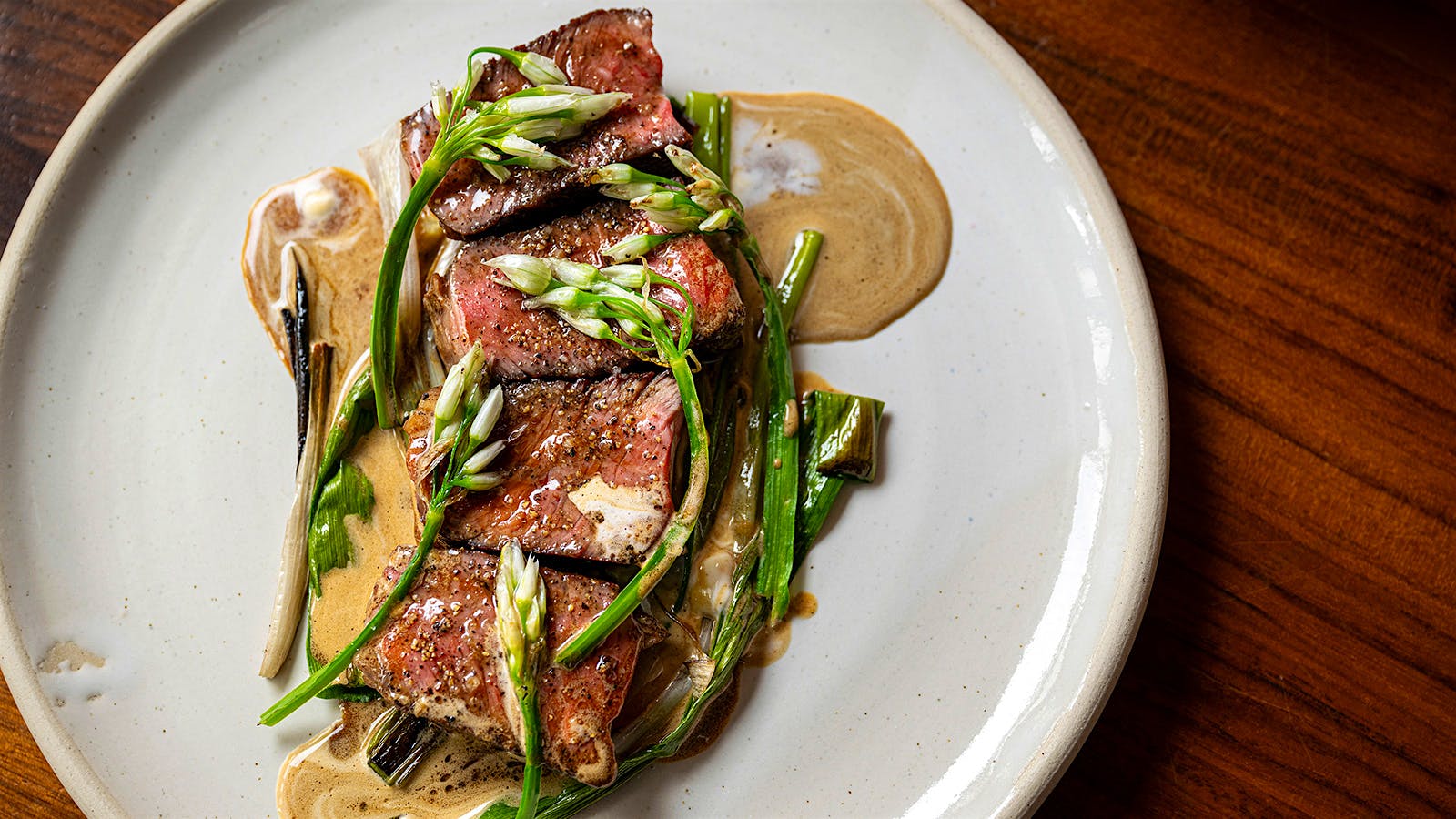 Arthur’s focus on East Coast ingredients shines in dishes like this Highland Hollow Farm steak with onion blossoms.