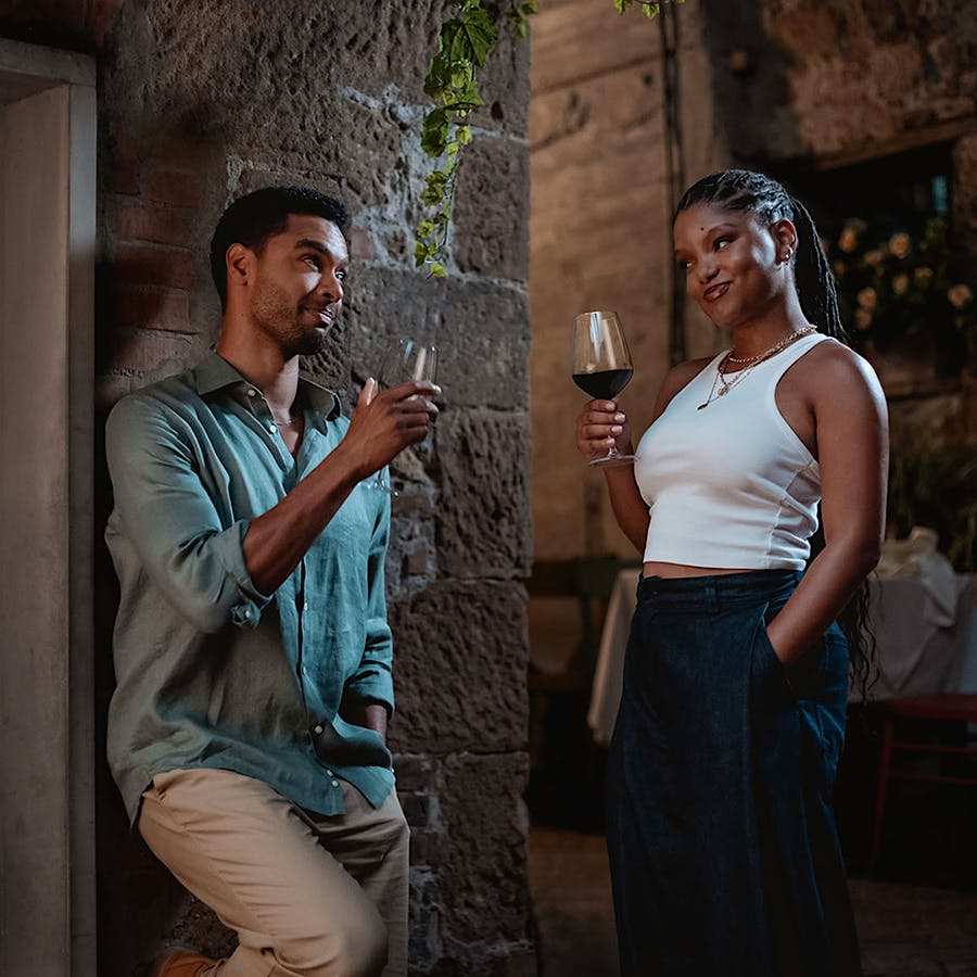 Wine tasting leads to sparks flying for Halle Bailey and Regé-Jean Page in <i>You, Me & Tuscany</i>.