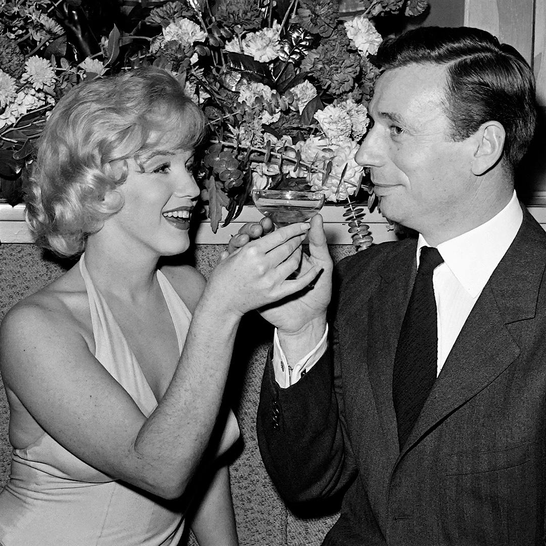 Marilyn Monroe and her Let’s Make Love co-star, French actor and singer Yves Montand, share a glass of Champagne in 1960 in Hollywood.