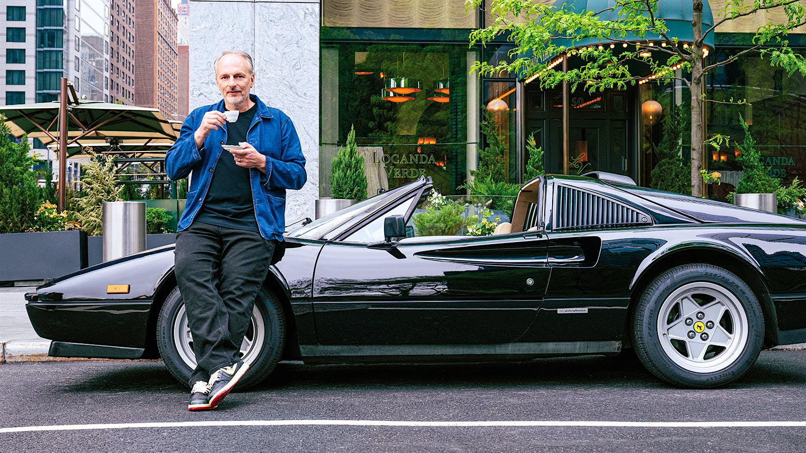Andrew Carmellini outside his Locanda Verde location at New York’s Hudson Yards, alongside a Ferrari driven in <i>Magnum, P.I.</i>