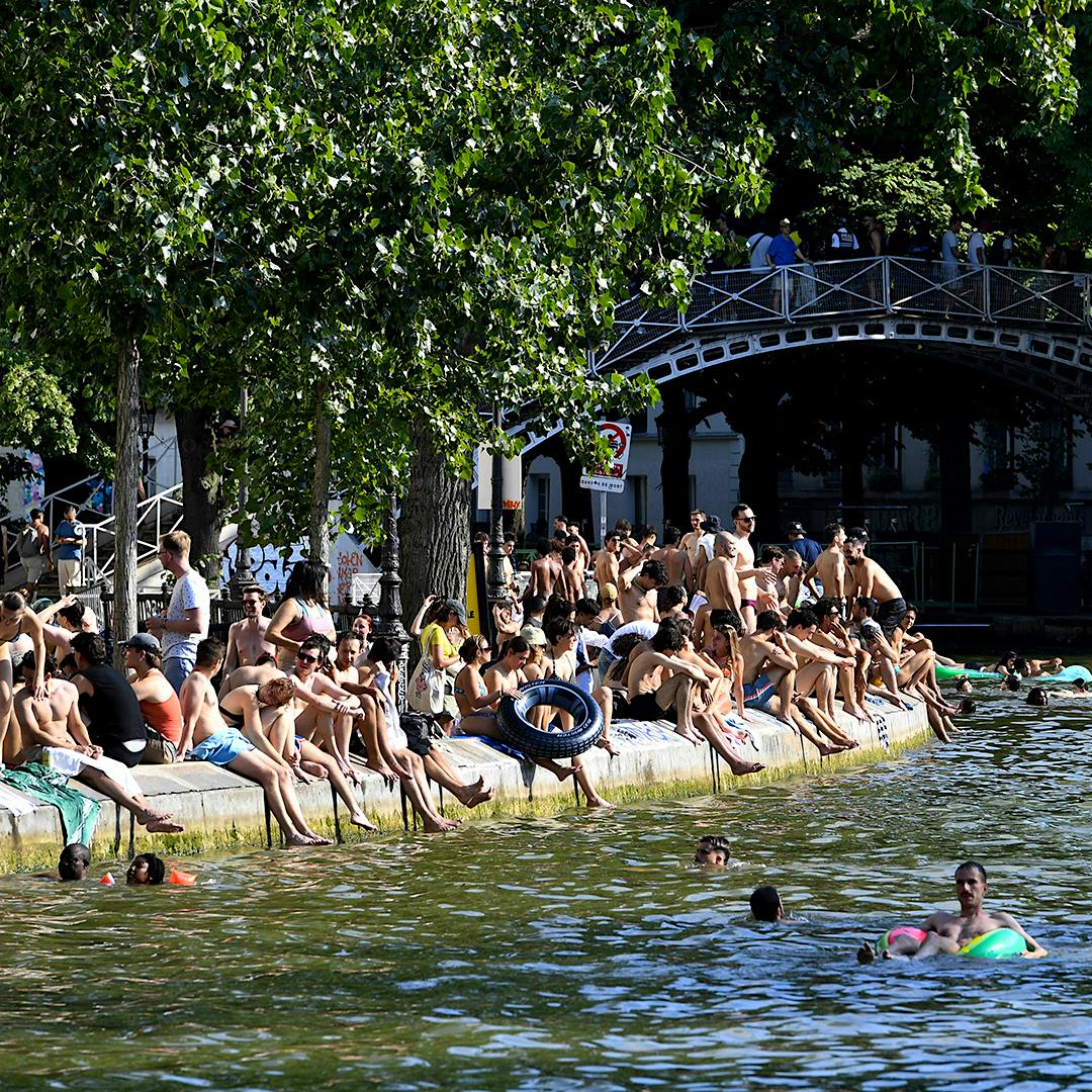 Swimming is normally banned in Canal-St.-Martin in Paris, but residents are eager to beat the heat any way they can.