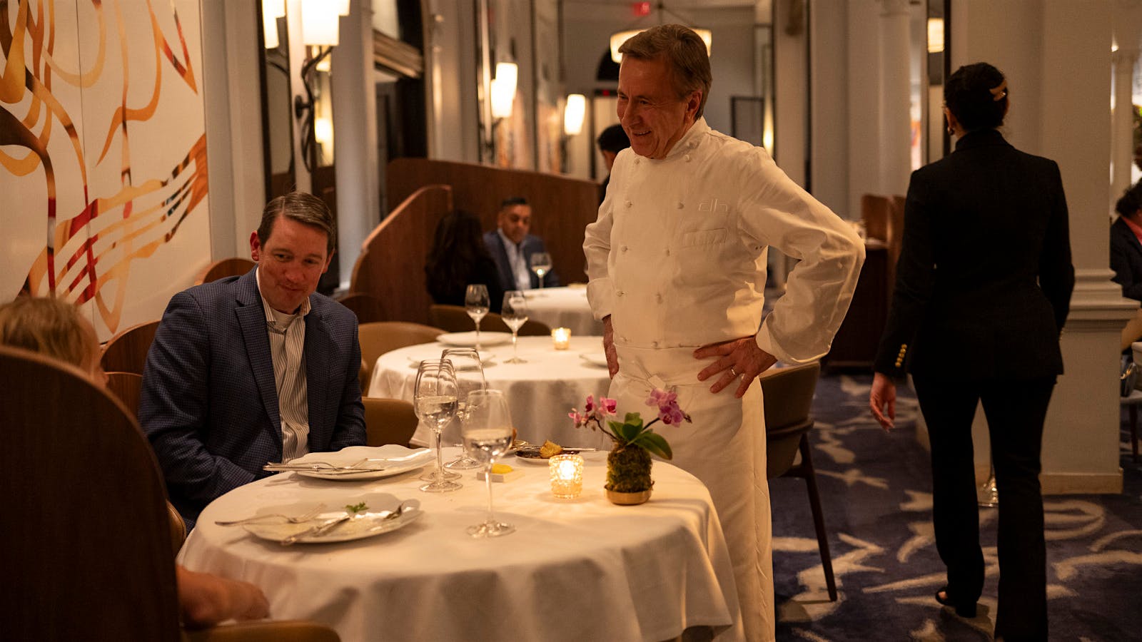  Chef Daniel Boulud with guests in the dining room of Daniel in New York City