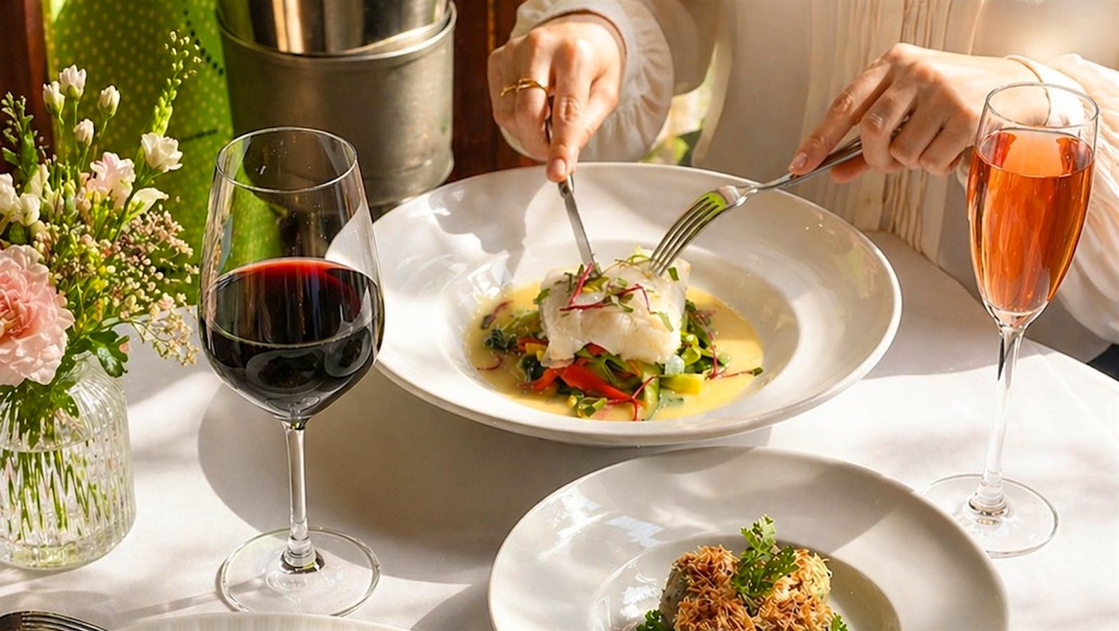 Pasta and a selection of side dishes with glasses of wine from Nice Matin.