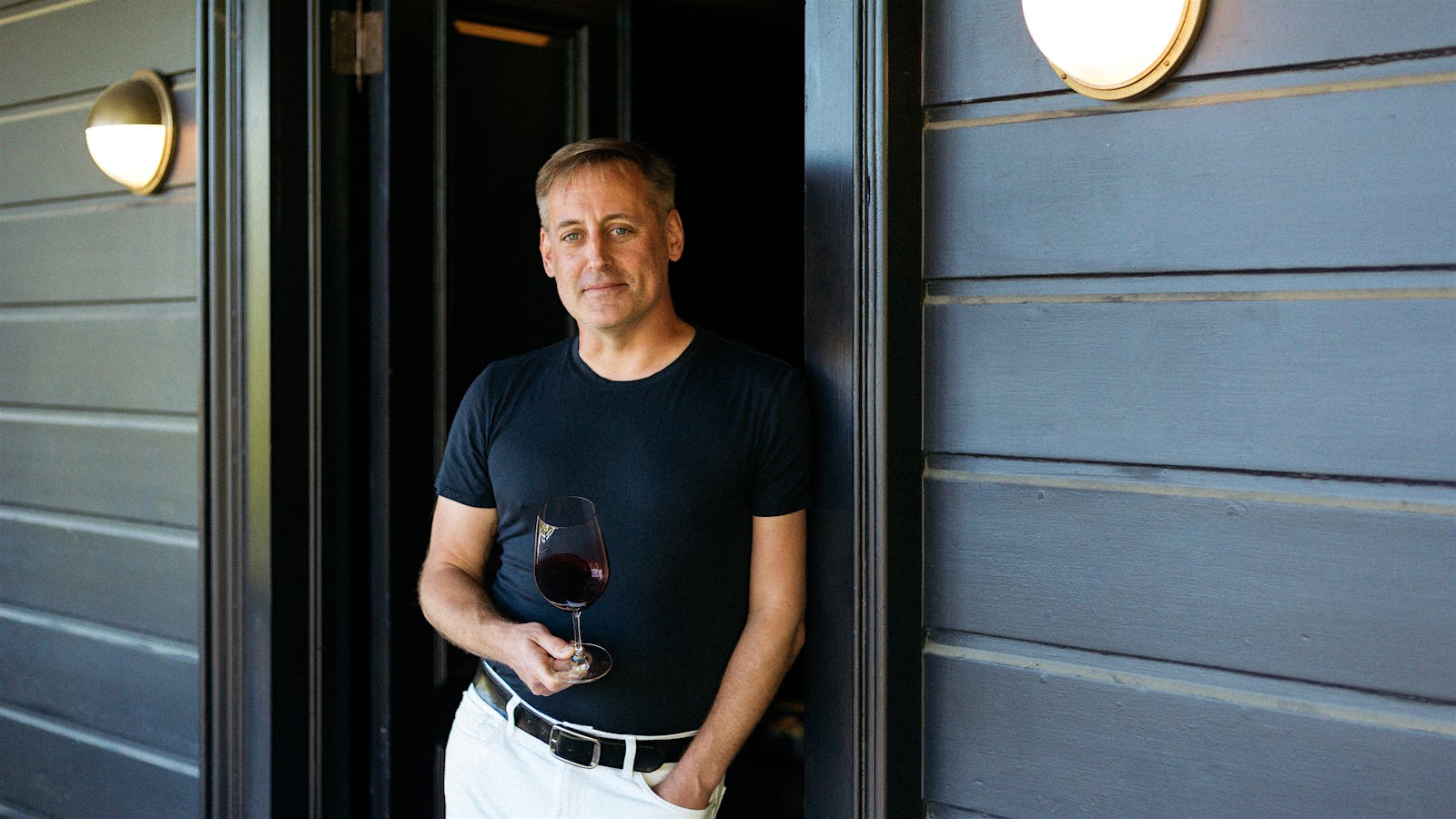 A portrait of senior editor James Molesworth holding a wineglass