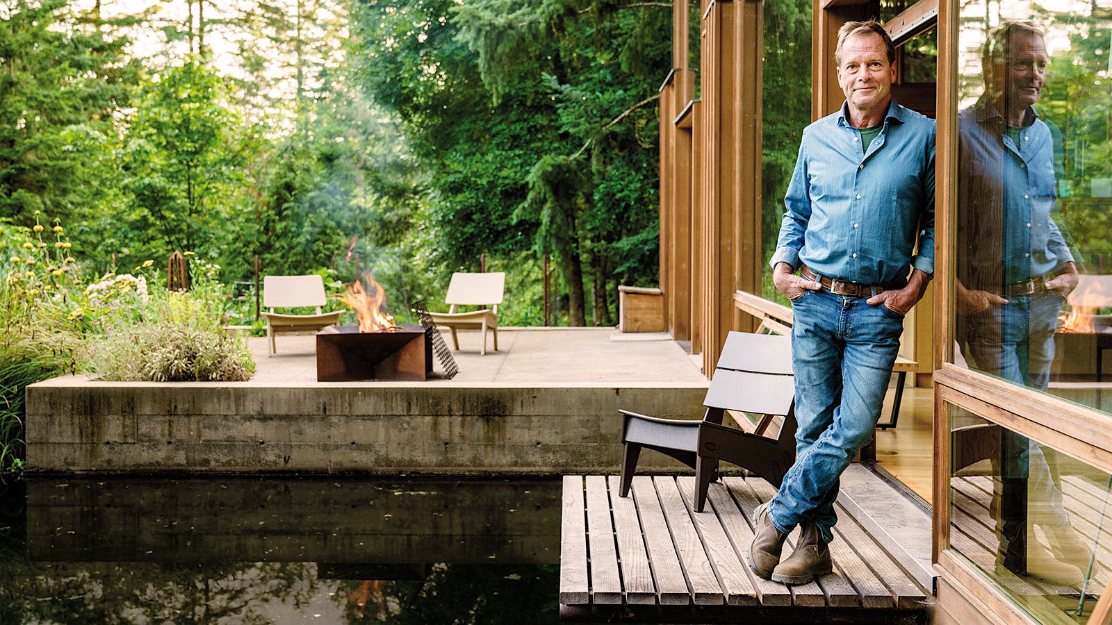 Mike Etzel standing on a porch leaning against a doorway