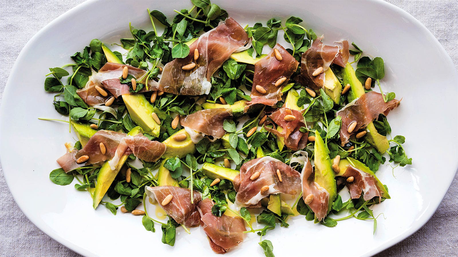 Pinkerton Avocados with Pea Shoots, Toasted Pine Nuts and Prosciutto
