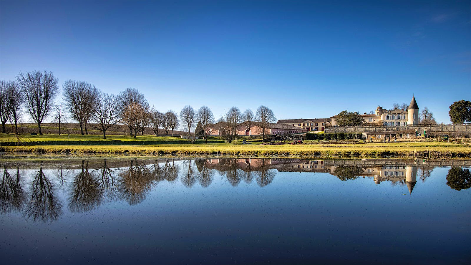 Pauillac's Château Lafite Rothschild reflected in the still waters of a pond