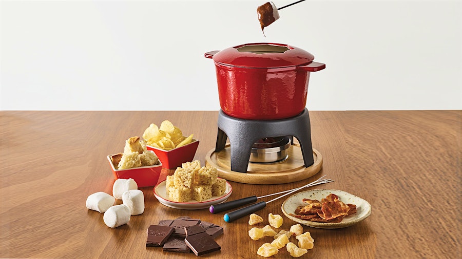 Swissmar's cast iron fondue set heats slowly and keeps its temperature. Its heft makes it solid, and the partial lid has notches to prop your forks on.