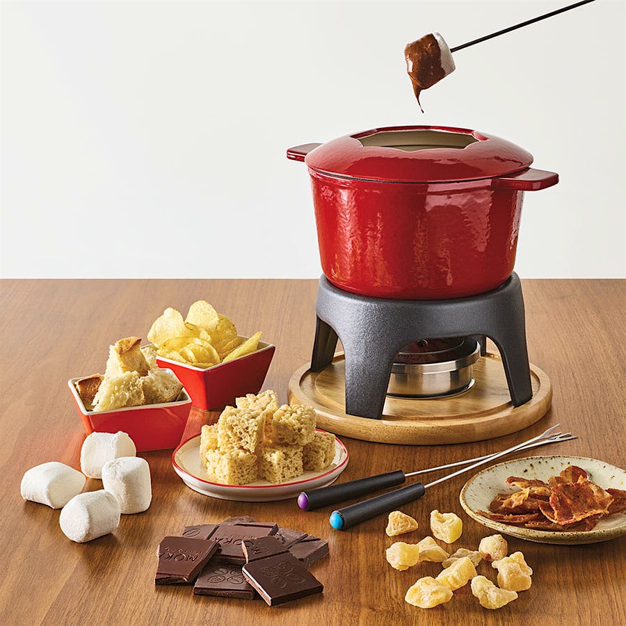 Swissmar's cast iron fondue set heats slowly and keeps its temperature. Its heft makes it solid, and the partial lid has notches to prop your forks on.