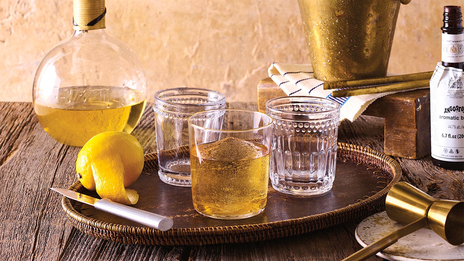 Glassware with brass cocktail equipment, filled with aged tequila