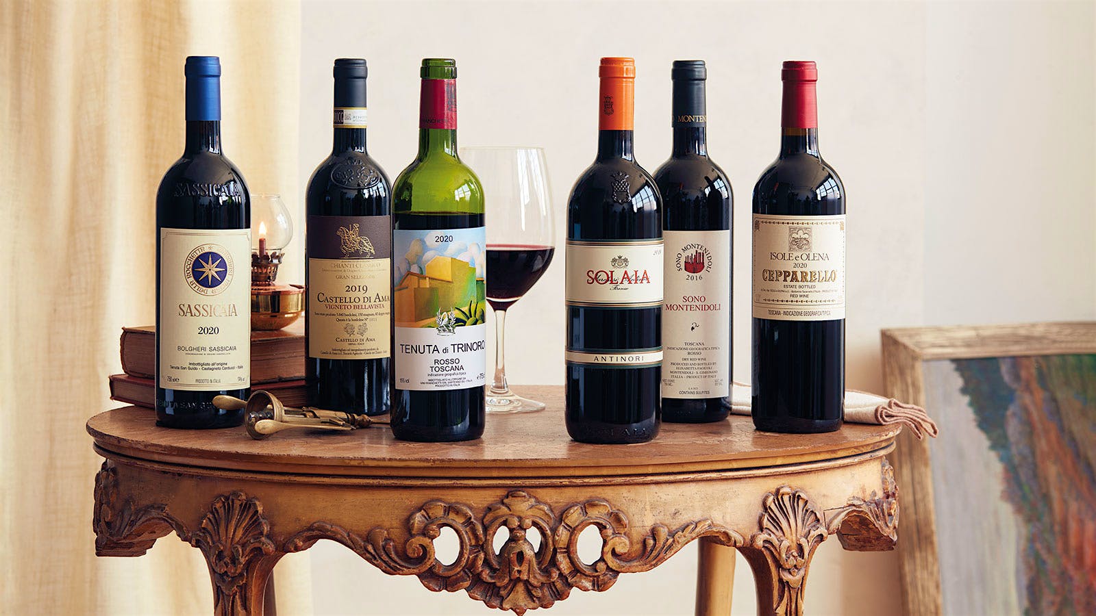 Bottles of Tuscan red wines presented on an ornate wooden table