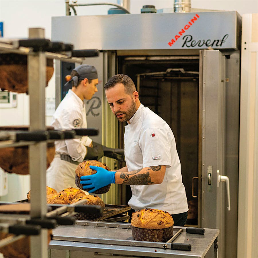 Bakers at Olivieri 1882 perform the crucial step of hanging the loafs upside down.