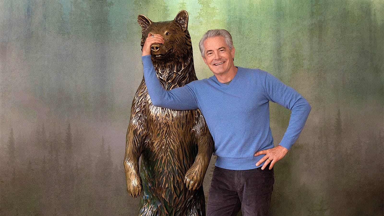 Kyle MacLachlan with a life-sized bronze sculpture of a bear in the tasting room of his winery, Pursued by Bear, in Washington, USA