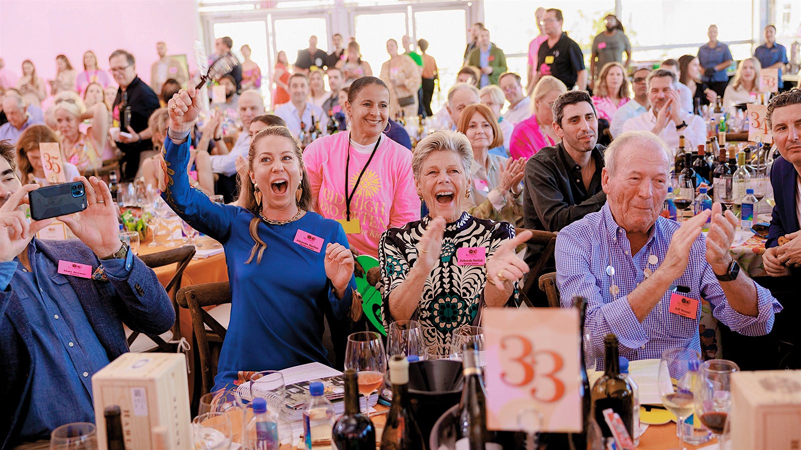 The Harlan family of Harlan estate cheer at their table at the Naples Winter Wine Festival.