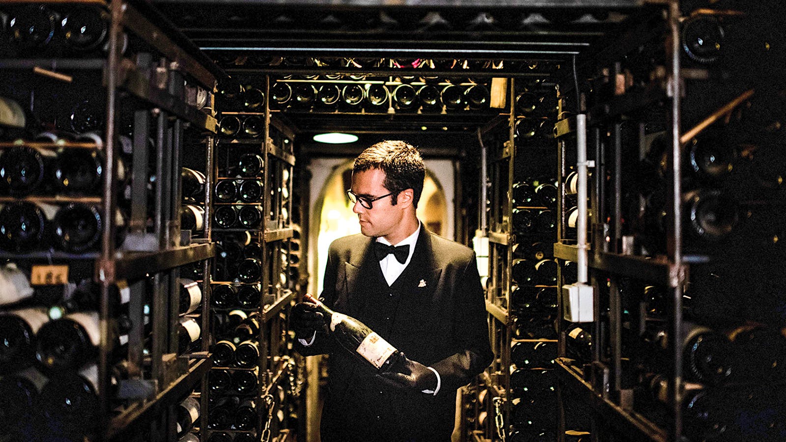 A sommelier inspects a bottle of wine in Le Tour d’Argent’s cellar.