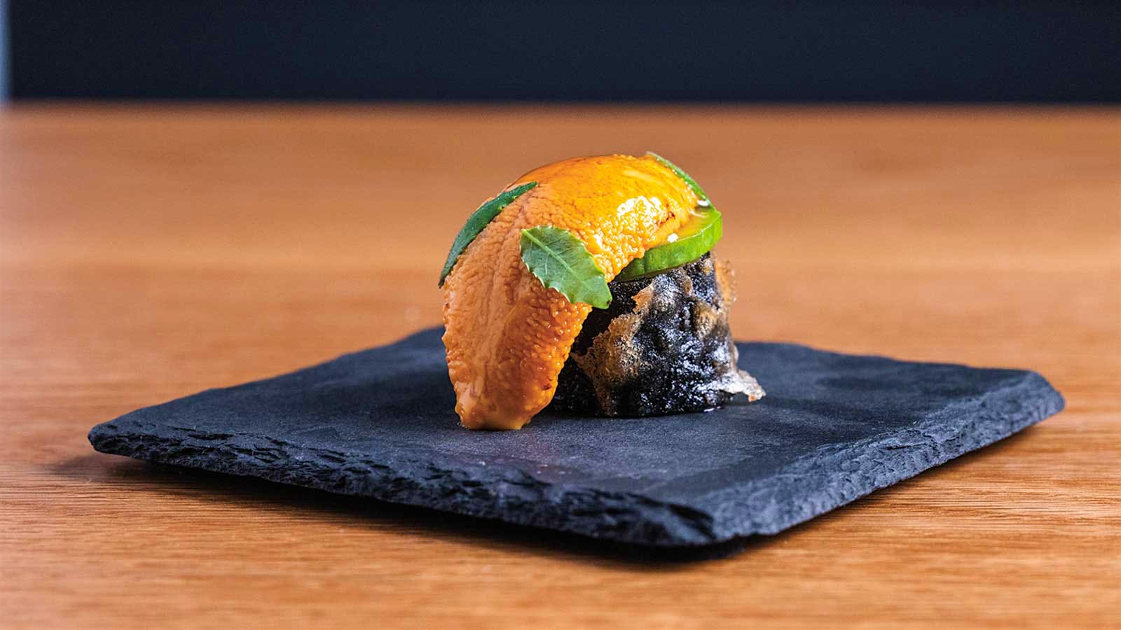 Nisei's uni preparation on a slate dish