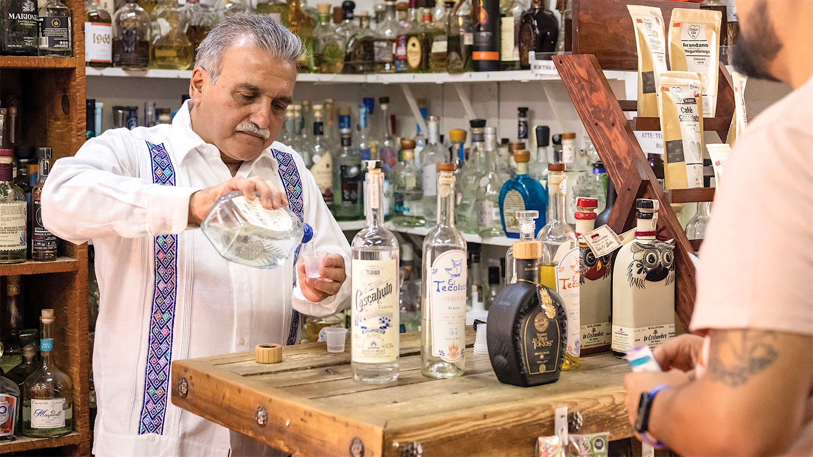 Emilio Ferreira Ruiz pours a tasting portion of tequila for a visitor at his shop, El Buho, in Jalisco, Mexico.