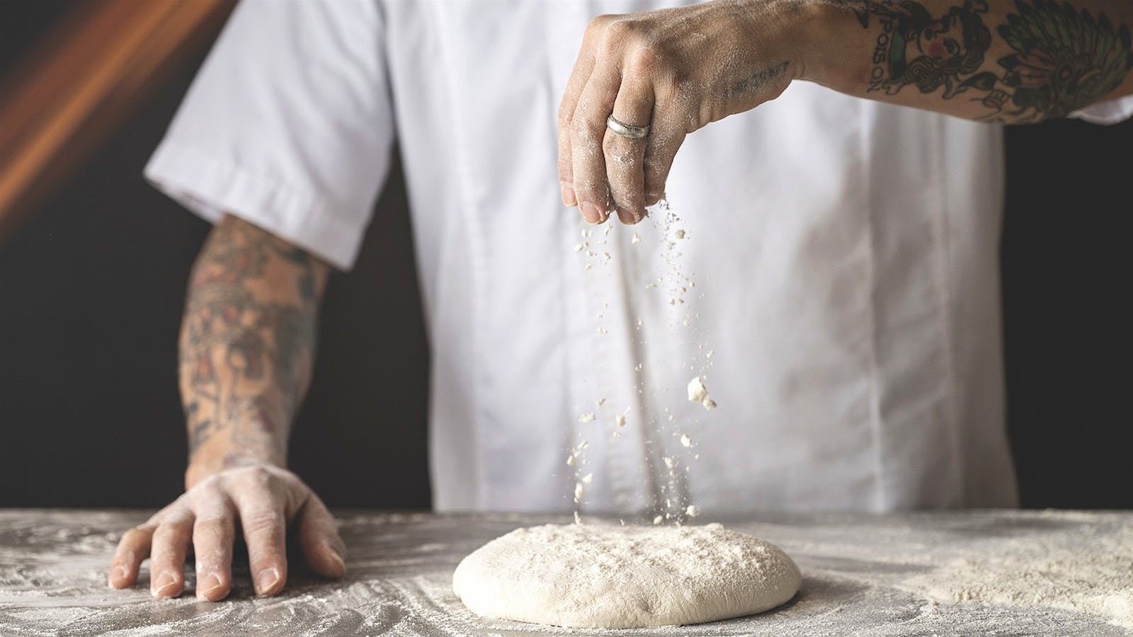 Tony Gemignani sprinkles pizza dough with flour in the kitchen of Tony's Pizza Napoletana.