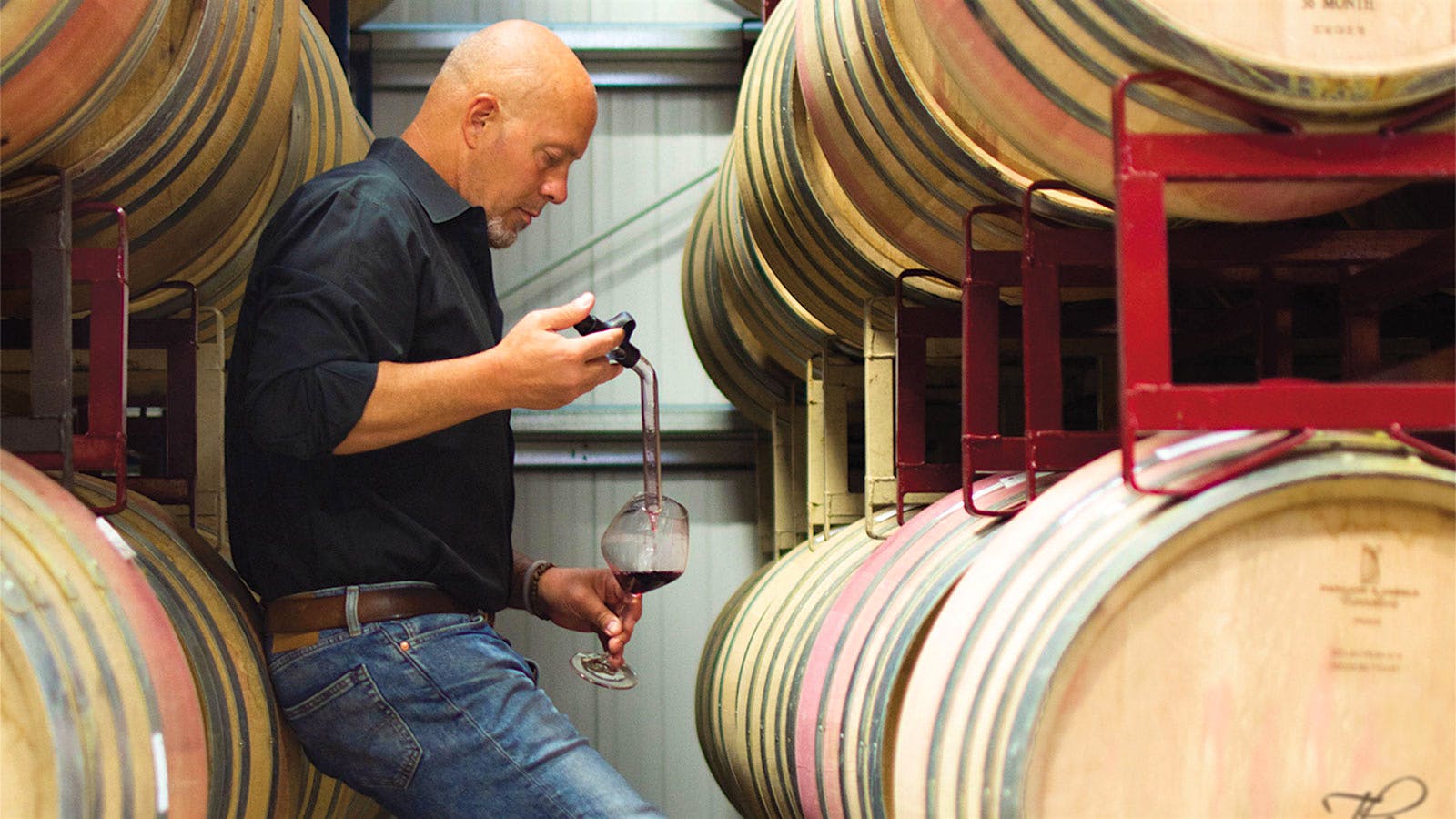 James MacPhail tastes wine from the barrel at his winery in Anderson Valley, California.