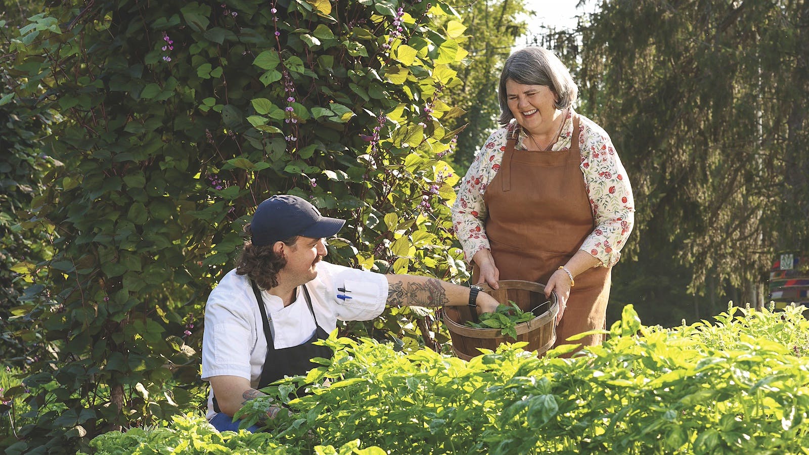 Ouita Michel and Tyler McNabb harvest vegetables in a garden outside Holly Hill Inn in Kentucky