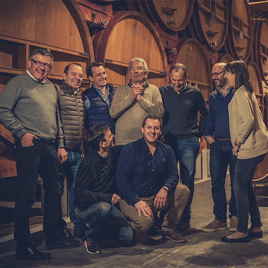 The fifth and sixth generations of the Perrin family in Beaucastel’s historic barrel room cellar, built in the 17th century. With its stacked barrels and large wooden vats, it’s one of the most recognizable cellars in the world.