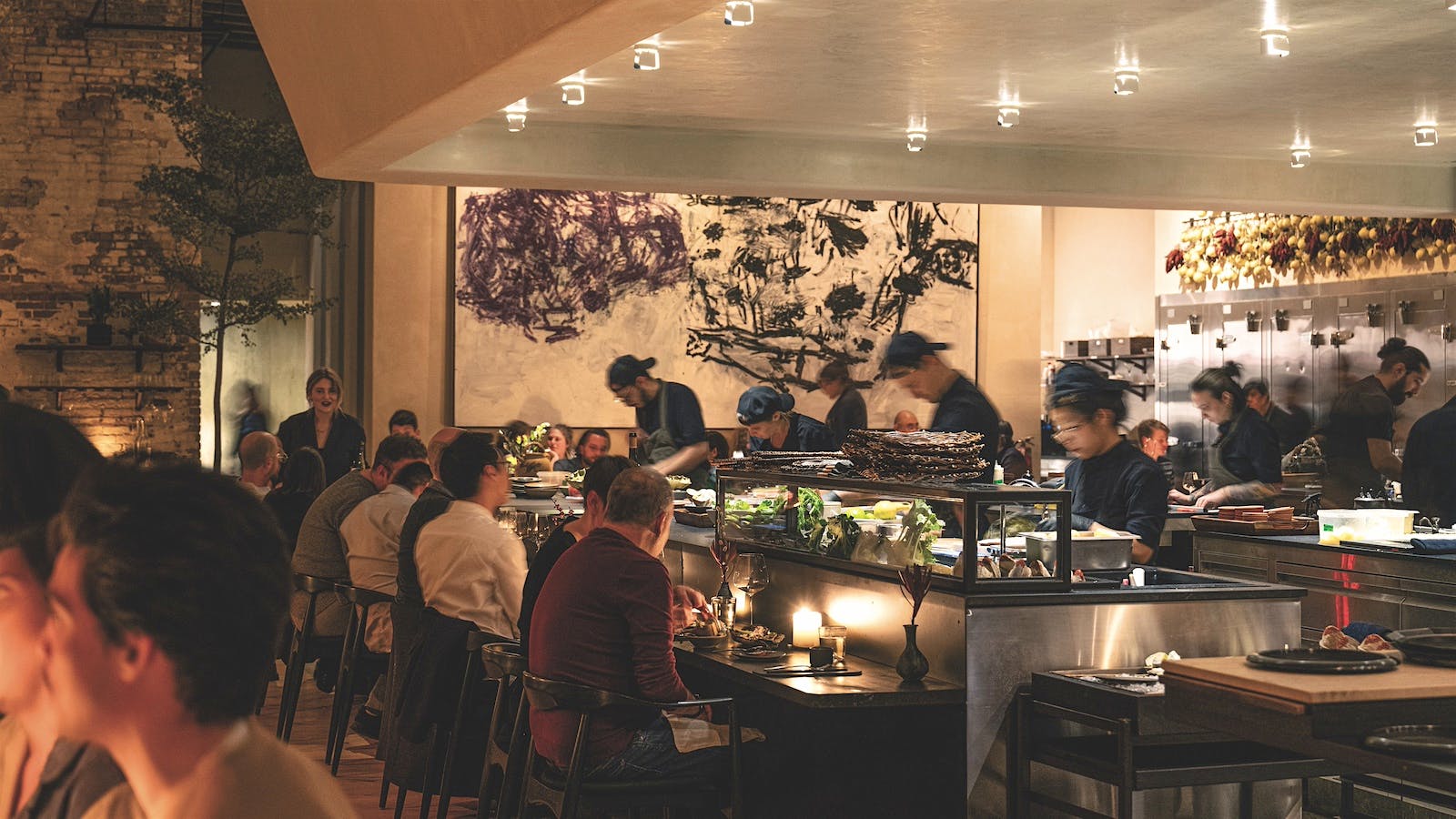 The dining room at ILIS, which looks into the kitchen where chefs prepare food, in Brooklyn, New York
