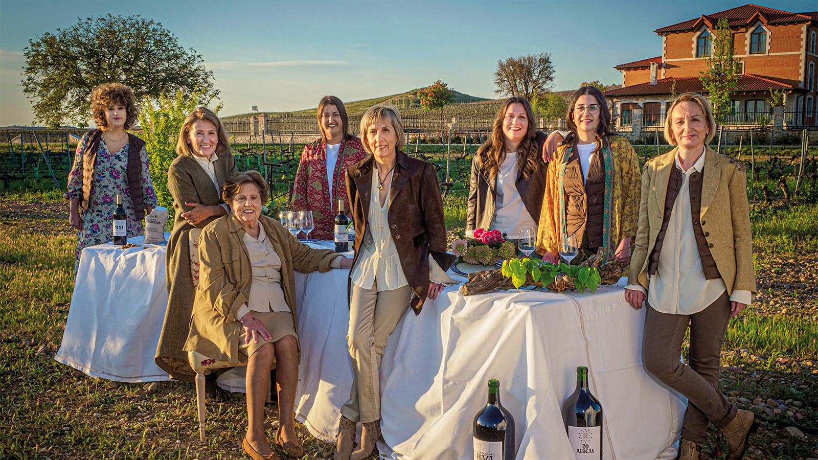 Eight women, representing three generations of the Fern&aacute;ndez Rivera family, gather at a table on the grounds of their estate house in Ribera del Duero, Spain.] 