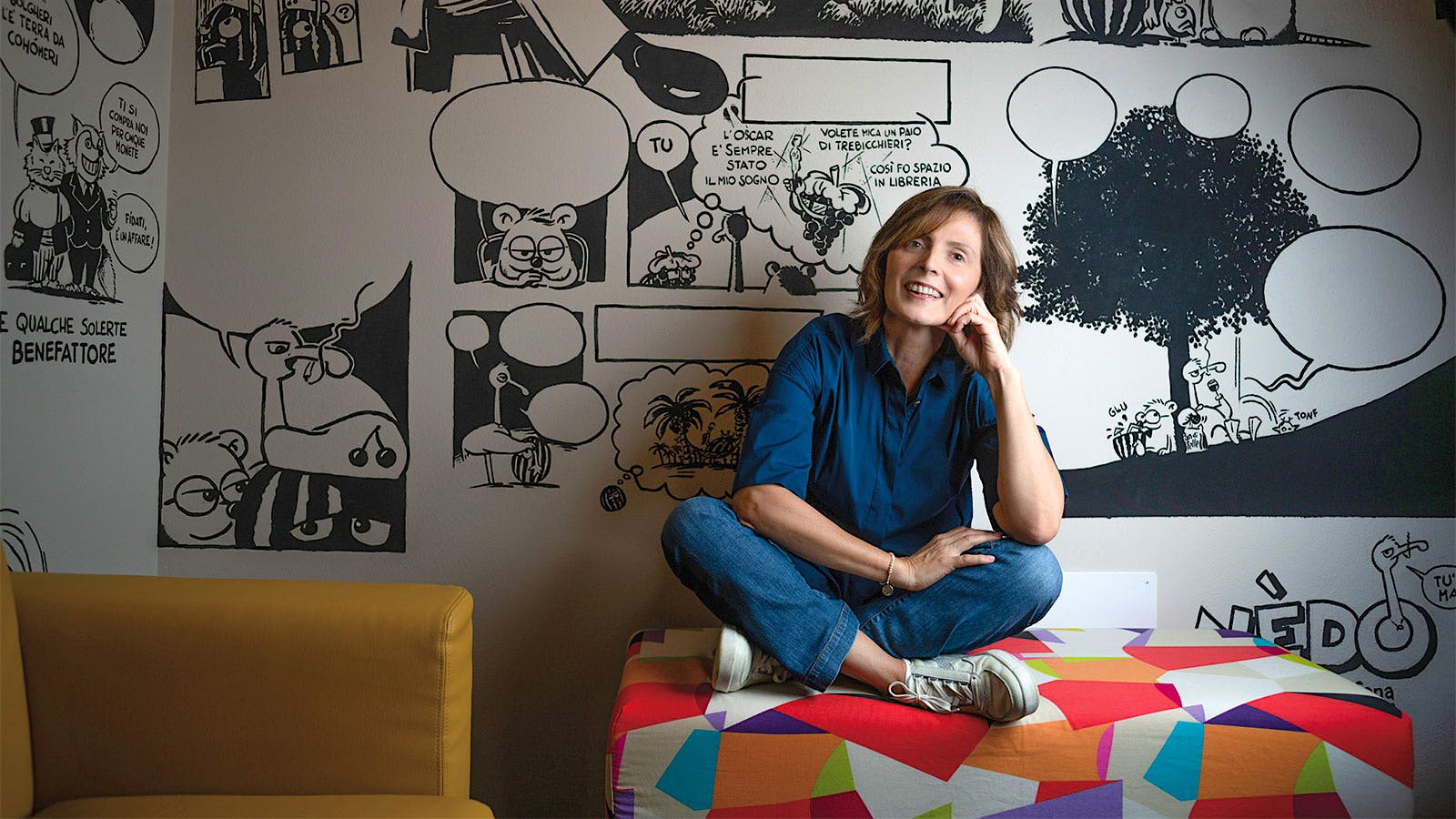 Portrait of Le Macchiole's Cinzia Merli in front of a cartoon wall