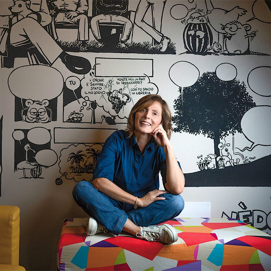 Portrait of Le Macchiole's Cinzia Merli in front of a cartoon wall