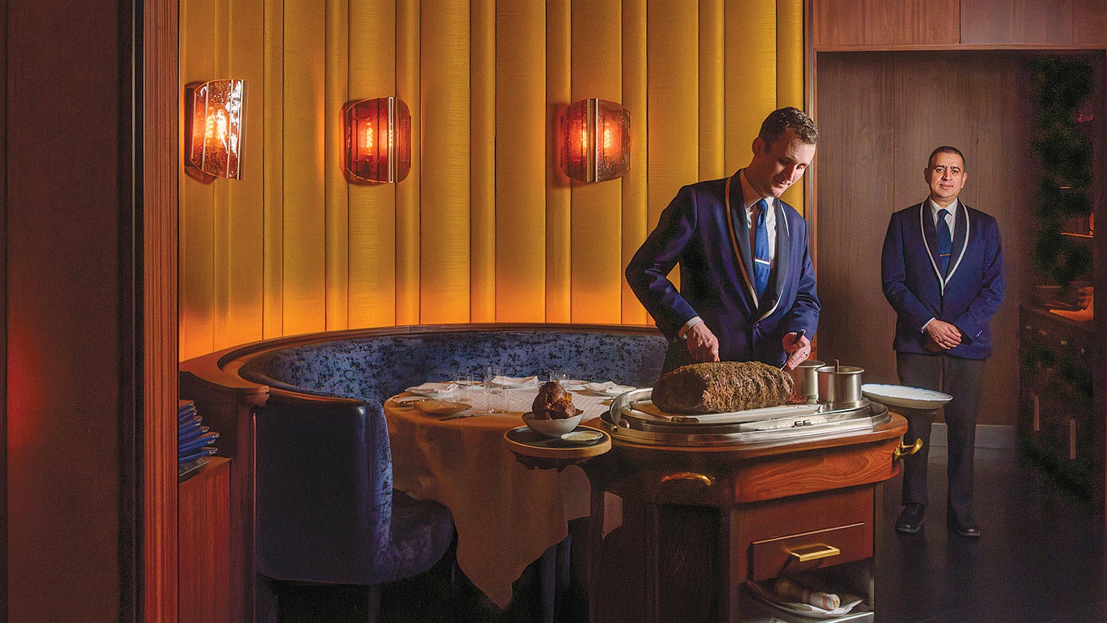 A server carves a roast tableside at La T&ecirc;te d&rsquo;Or by Daniel in New York