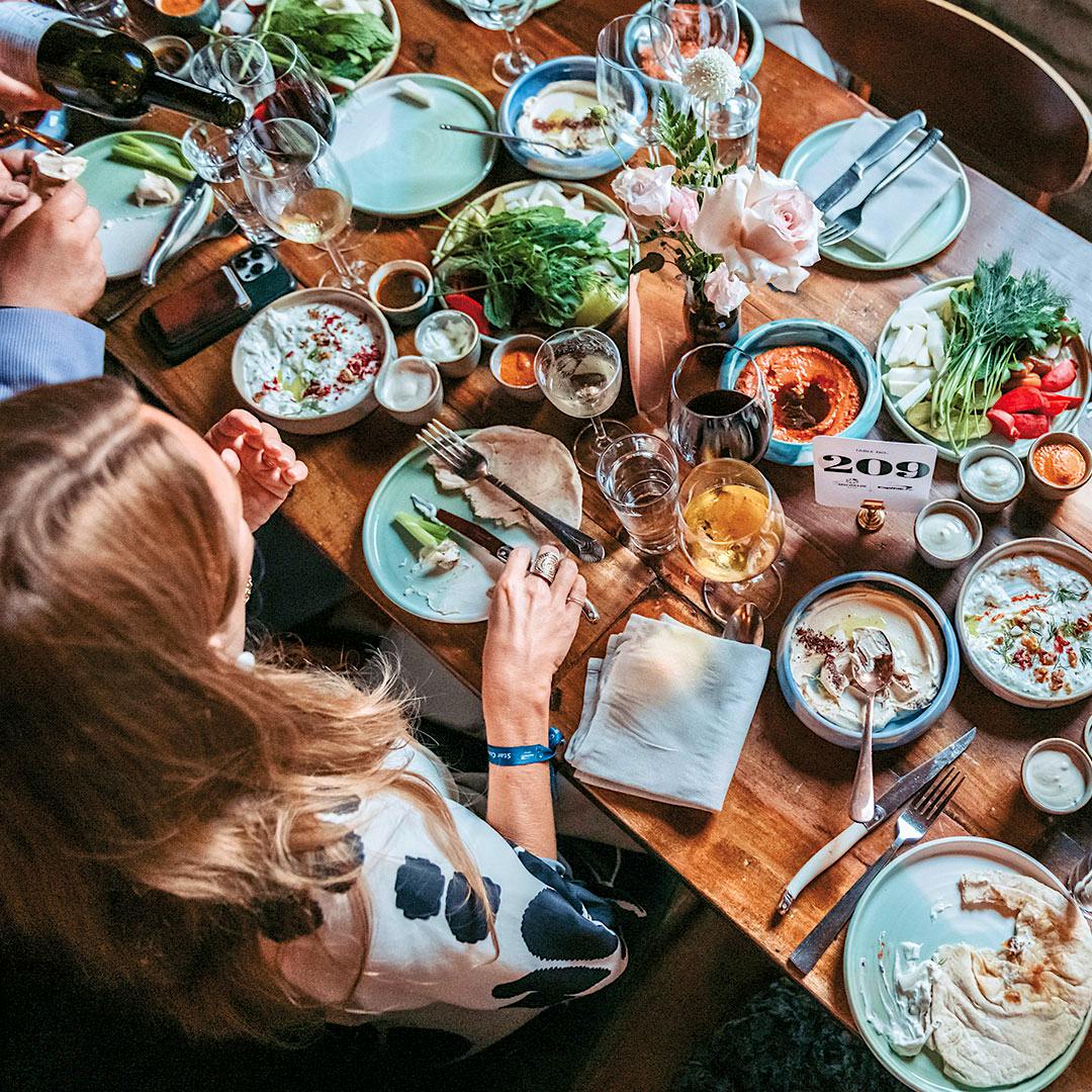 Gather friends and family for a laden <em>supra</em> table, like this feast at Maydān in Washington, D.C.