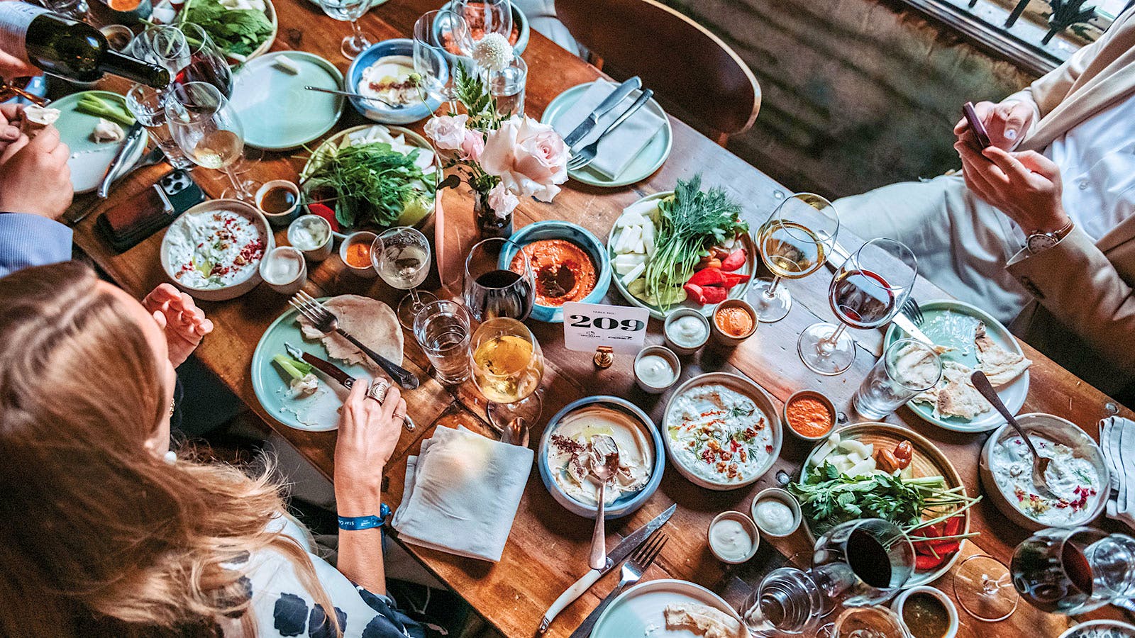 Gather friends and family for a laden <em>supra</em> table, like this feast at Maydān in Washington, D.C.